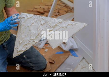 Spreading wet mortar before applying tiles on bathroom floor tile. Stock Photo