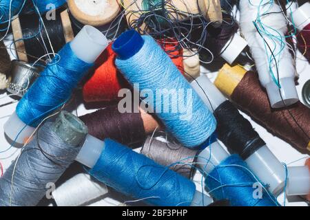 Tangled threads for sewing. different spools of thread Stock Photo