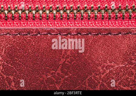 Red leather texture with zipper closure. material with seams macro background Stock Photo