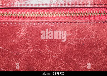 Red leather texture with zipper closure. material with seams macro background Stock Photo