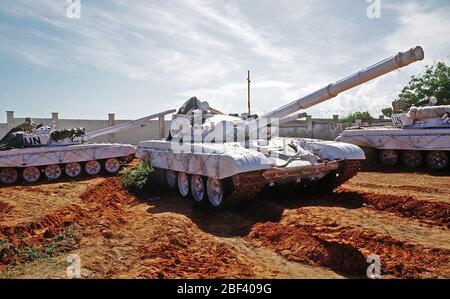 United Nations tanks at the Belgian compound in Kismayo.  3/4 right side view of a T-72 main battle tank with UN markings.  The UN forces are in Somalia in support of OPERATION CONTINUE HOPE.