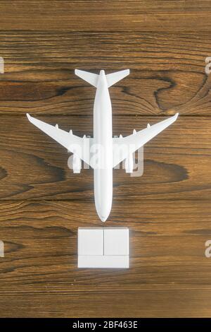Airplane with wooden cubes on which you can enter your date stands on a wooden table Stock Photo