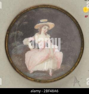 Button. Button showing a female figure in costume of late 18th century; covered with glass; mounted in copper rim; back with tin.On card 69 Stock Photo