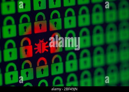 Bug as a symbol of malware and a Trojan virus in the program code. Hacking and theft of personal information and data. Green pixel locks and red Bug on a black background, close-up. Stock Photo