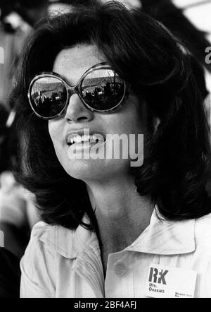 Former First Lady of the United States, JACQUELINE KENNEDY ONASSIS wearing large sunglasses at a sporting event. Stock Photo