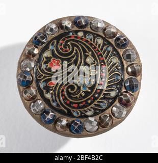 Buttons 2. (a) Brass button with design resembling Persian Cone stamped and painted in color, surrounded by facetted boses of cut steel in various colors; brass shank.(b) Similar button in smaller size. Component -b is on card 42. Stock Photo