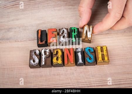 Learn Spanish. Internet training, course and webinar concept. Colored wooden letters on a light background Stock Photo