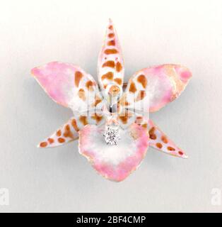 Brooch. Enameled gold brooch in the shape of an six-petal orchid with diamons in the center of "flower." Stock Photo