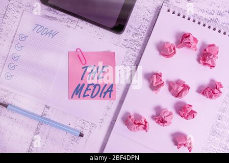 Handwriting text The Media. Conceptual photo main means of mass communication that are regarded collectively Squared spiral notebook marker smartphone Stock Photo