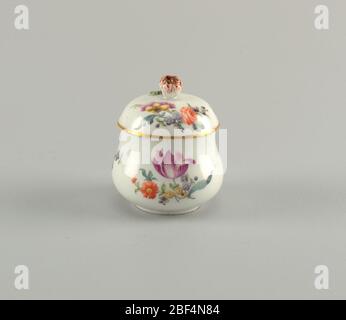 Sugar Bowl with Flowers. Sugar bowl and cover part of a personal traveling tea-set. white porcelain with floral sprays and cover with flower handle. Stock Photo