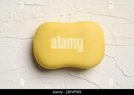 Yellow Color Soap Isolated on Texture Crack  White Background. Stock Photo