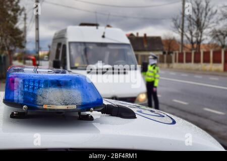 Cluj-Napoca,Cluj/Romania-03.26.2020-Police car lights on, blue and red. Lights mounted on top of romanian police car, Dacia Logan Stock Photo