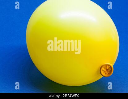 a yellow balloon on blue background Stock Photo