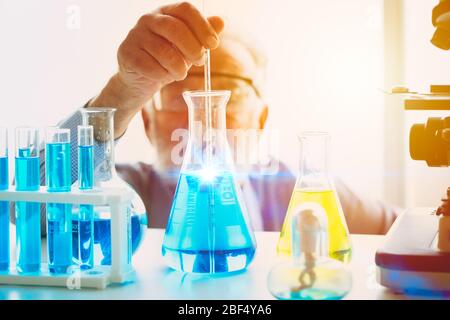 Scientist looking focus on new chemical vaccine formula successful to discover science research drug anti virus working in laboratory concept Stock Photo