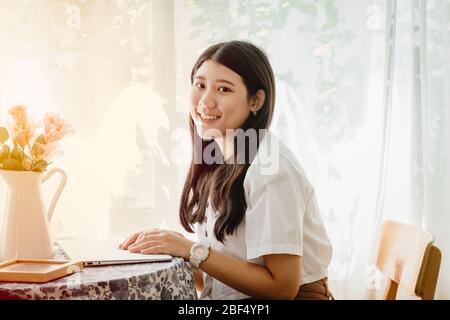 Asian cute girl teen smiling in the house for Asia young house wife happy enjoy lifestyle at home. Stock Photo