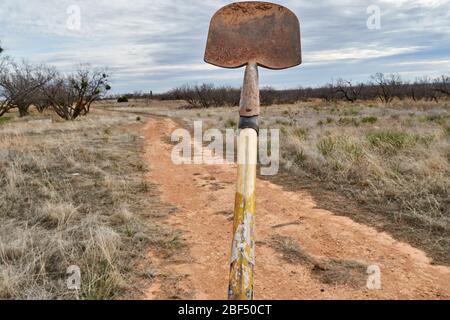 Old dirty shovel isolated on Texas desert background Stock Photo