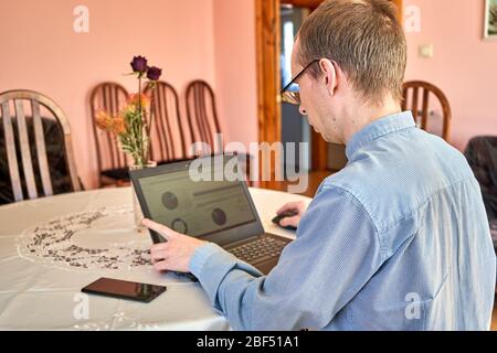 Businessman working with their laptop at home office. Stock Photo