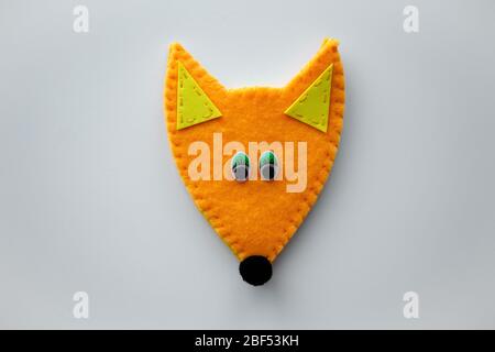 Cute felt fox DIY step by step tutorial. Handmade purse or toy sewing process. Orange wild animal with green eyes and yellow foamiran ears. Easy craft for kids Stock Photo