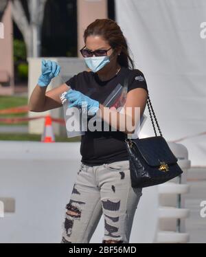 Los Angeles, United States. 17th Apr, 2020. A woman administers her self-testing coronavirus kit at the Charles M. Drew Campus in Los Angeles on Thursday, April 15, 2020. Testing has fallen woefully short as President Trump seeks an end to stay-at-home orders. Flawed tests, scarce supplies and limited access to screening have hurt the U.S.'s ability to monitor COVID-19, governors and health officials warn. Photo by Jim Ruymen/UPI Credit: UPI/Alamy Live News Stock Photo