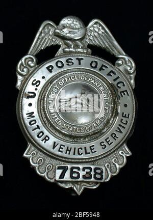 MVS employee chest badge number 7638. U.S. Post Office Department Motor Vehicle Service (MVS) chest badge, number 7638, with vertical hinged pin and clasp on verso. Spread eagle surmounts circular medallion with upper portion marked 'U.S. Stock Photo