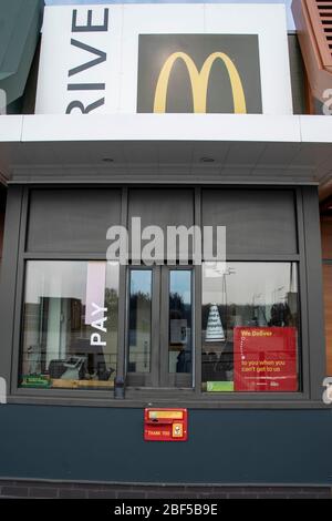 Sheffield UK –  April 09 2020: Covid-19 pandemic closure sign reads No Cash, Food or Supplies left on the premises in the drive through window at Hand Stock Photo