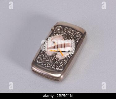 Cigar and Matches. Rectangular, with rounded corners, featuring raised scroll and bead ornament, beads frame asymmetrical, enameled, central reserve depicting a burning, brown cigar, beneath which are two wooden matches, one of which is burnt. Stock Photo