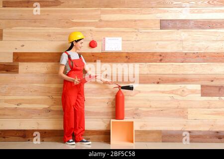 Fire safety specialist inspecting extinguisher Stock Photo