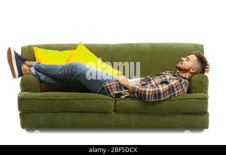 Young man relaxing on sofa against white background Stock Photo