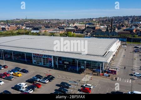 People queue 2 metres apart for a long distance outside of the Tesco extra store in Longton, Stoke on Trent, Social distancing, Covid 19, Coronavirus Stock Photo