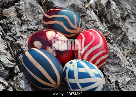 Easter eggs uniquely painted on a walnut bark background Stock Photo