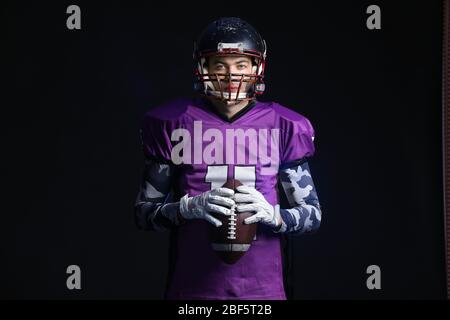 American football player on dark background Stock Photo