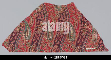 Fragment. Fragment with an allover design of wavy vertical stripes and paisleys filled with a small floral pattern and some stippling in red, blue, green and yellow. Stock Photo