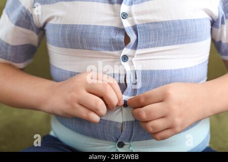 Overweight boy in tight clothes, closeup Stock Photo