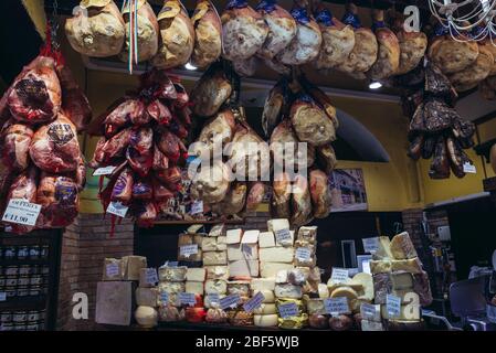 Meat and cheese for sale on Mercato di Mezzo food market in Bologna, capital and largest city of the Emilia Romagna region in Northern Italy Stock Photo