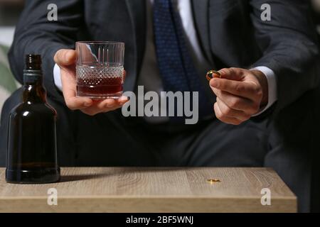 Divorced man drinking cognac at home. Concept of alcoholism Stock Photo