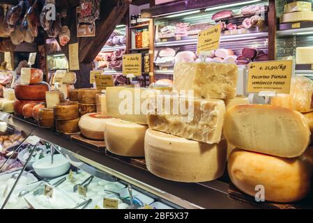 Meat and cheese for sale on Mercato di Mezzo food market in Bologna, capital and largest city of the Emilia Romagna region in Northern Italy Stock Photo