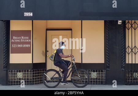 Pasadena, United States. 17th Apr, 2020. A man rides past a boarded up acting studio in West Hollywood on Thursday, April 16, 2020. Trump unveiled a plan to reopen state economies in the coming months in phases, reassuring them they would be handling it themselves, with help from the federal government. Photo by Jim Ruymen/UPI Credit: UPI/Alamy Live News