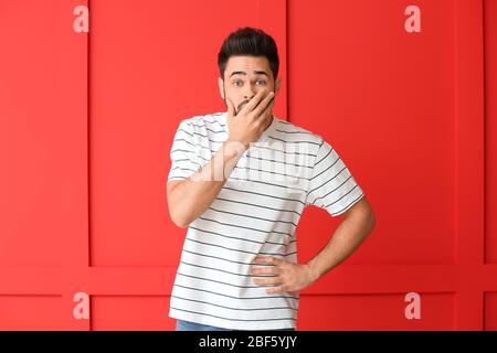 Portrait of worried young man on color background Stock Photo