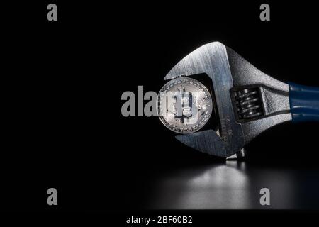Silver bitcoin on the reflective desk, closeup. Cryptocurrency virtual money. Exchange, anonymous. Bitcoin is an open source web cash currency. Black Stock Photo