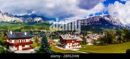 Panoramic view on italian town Cortina d'Ampezzo and mountains (Monte Cristallo, Monte Antelao) surrounding it. Stock Photo