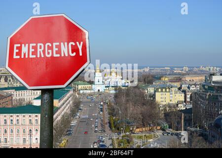 Emergency sign on Kyiv view background. Financial crash in world economy because of coronavirus. Global economic crisis, recession Stock Photo