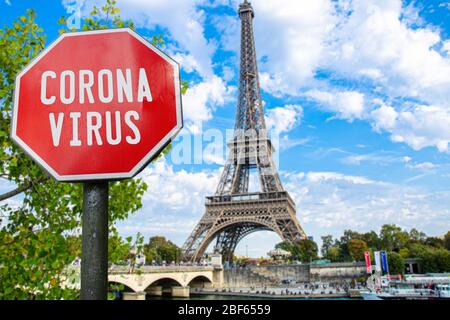 Corona virus sign with Eiffel tower in Paris, France. Warning about pandemic in France. Coronavirus disease. COVID-2019 alert sign Stock Photo