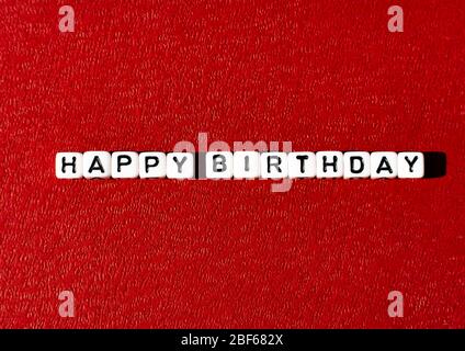 Happy Birthday postcard with white cubes on dark red background Stock Photo