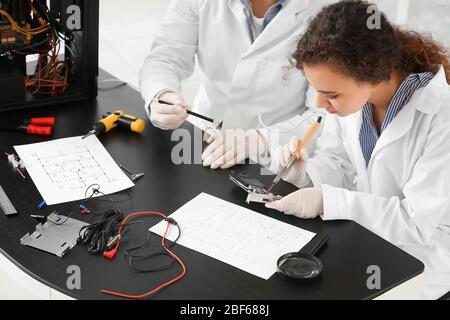 Electronic technicians working in service center Stock Photo