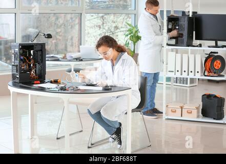 Electronic technicians working in service center Stock Photo