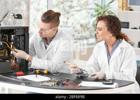 Electronic technicians working in service center Stock Photo