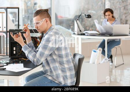 Electronic technician working in service center Stock Photo
