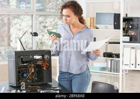 Electronic technician working in service center Stock Photo