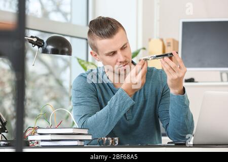 Electronic technician working in service center Stock Photo