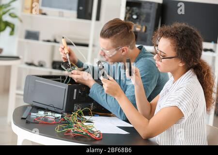 Electronic technicians working in service center Stock Photo